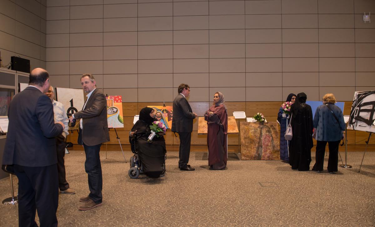 Attendees observe the works of several female Qatari artists, who showcased their work in an exhibition held to celebrate International Women’s Day